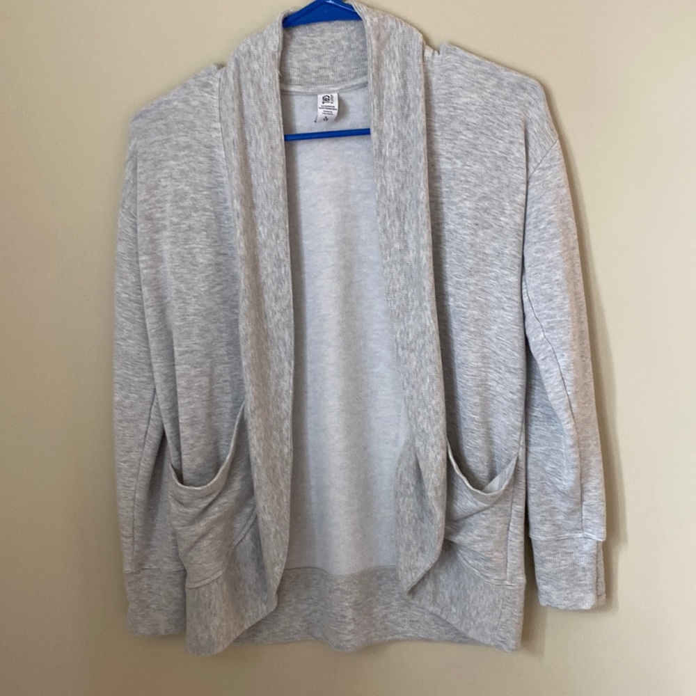 An Athleta girl gray colored sweater size L/12 with pockets